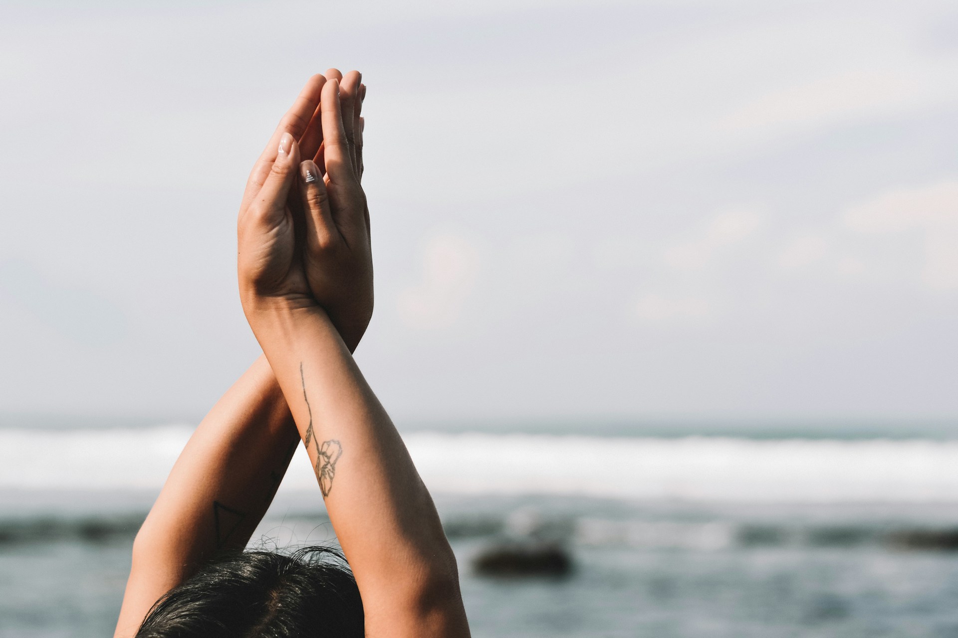 Woman's hands by ocean
